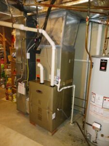 A Carrier furnace and water heater installed in a utility space by MMI Climate Solutions in Lexington, KY.