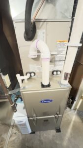 A Carrier furnace and air handler unit with an Aprilaire humidifier and ductwork installed by Bloomington Heating & Air in Bloomington, MN.