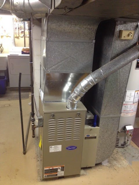 A Carrier furnace with new ductwork installed in a utility room by D &Sons Heating and Cooling LLC in Schenectady, NY