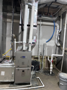 A Carrier furnace and ductwork installation in a utility room by Vanessa Service HVAC in Falls Church, VA.