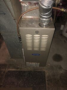 A Carrier furnace unit installed in a residential basement by Elements Heating & Cooling LLC in Minneapolis, MN.