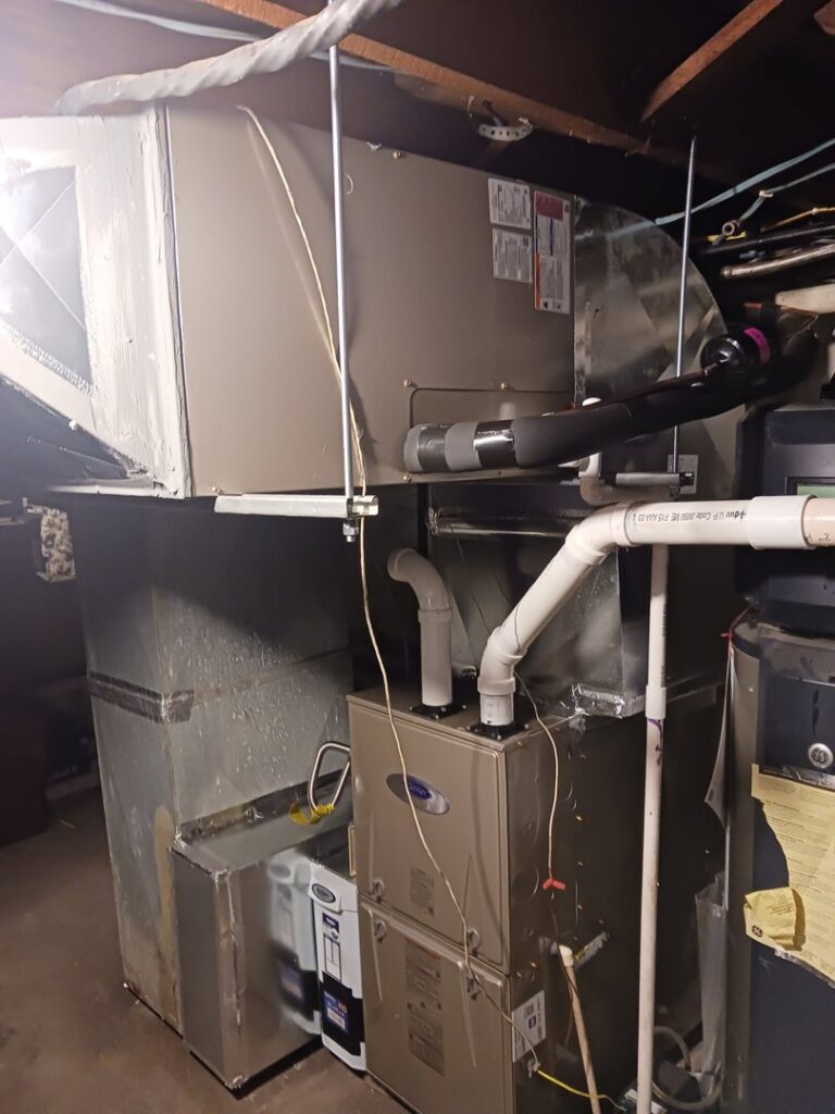 A Carrier furnace with an attached air purifier and ductwork installed by MMI Climate Solutions in Lexington, KY.