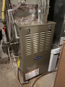 A Carrier furnace unit with an Aprilaire humidifier installed by Jackson Home Appliance Heating & Cooling in Omaha, NE