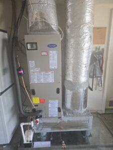 A Carrier HVAC furnace and air handler unit with insulated ductwork installed by Aire Care Mechanical in Knoxville, TN.