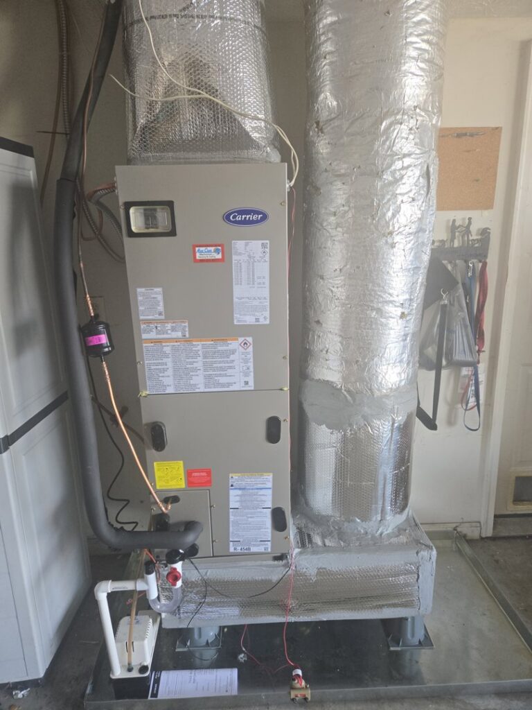 A Carrier HVAC furnace and air handler unit with insulated ductwork installed by Aire Care Mechanical in Knoxville, TN.
