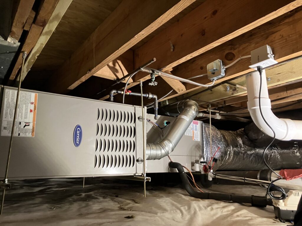 A Carrier HVAC furnace and ductwork installed in a home by Woodfin-Your Home Team in Richmond, VA.