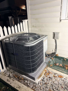 A Carrier outdoor air conditioning condenser unit installed beside a home by Fast Air in Zebulon, NC.