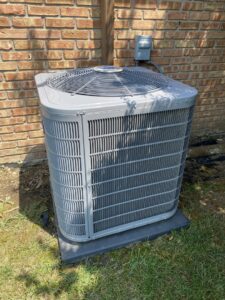 A newly installed Carrier outdoor air conditioning unit by Roy Rogers Heating and Air in Indianapolis, IN.