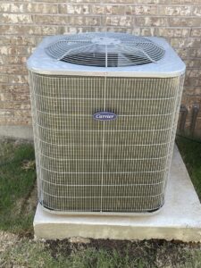 A clean Carrier brand outdoor HVAC unit installed by Modern Air Services in Fort Worth, TX.