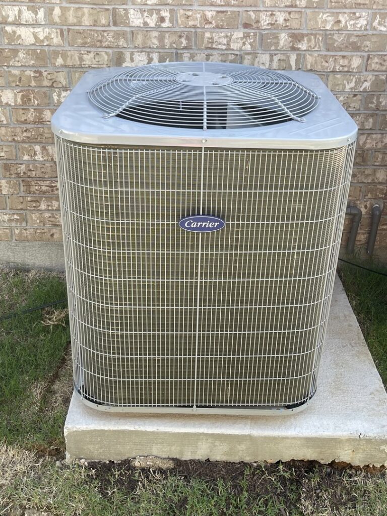 A clean Carrier brand outdoor HVAC unit installed by Modern Air Services in Fort Worth, TX.