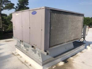 A Carrier commercial rooftop HVAC unit on a building, serviced by Raleigh Comfort Services in Raleigh, NC.