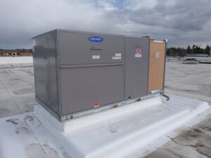 A newly installed Carrier WeatherMaker HVAC unit on a commercial rooftop by R&R Heating & Air Conditioning in Spokane, WA.