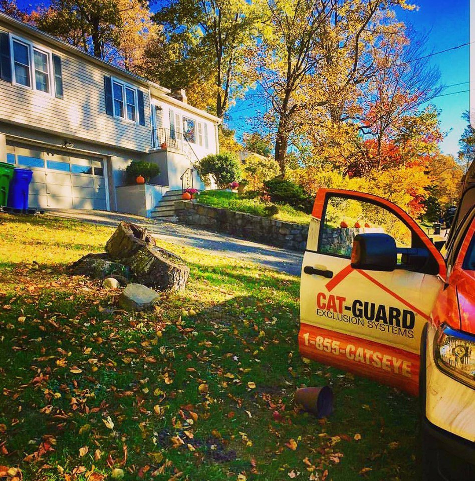 A Catseye Pest Control truck with Cat-Guard branding parked at a residential job site in Hartford, CT.