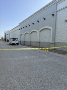 Caution tape and a warning sign around a commercial building during a pest control job by BeeCal Pest Management in Los Angeles, CA