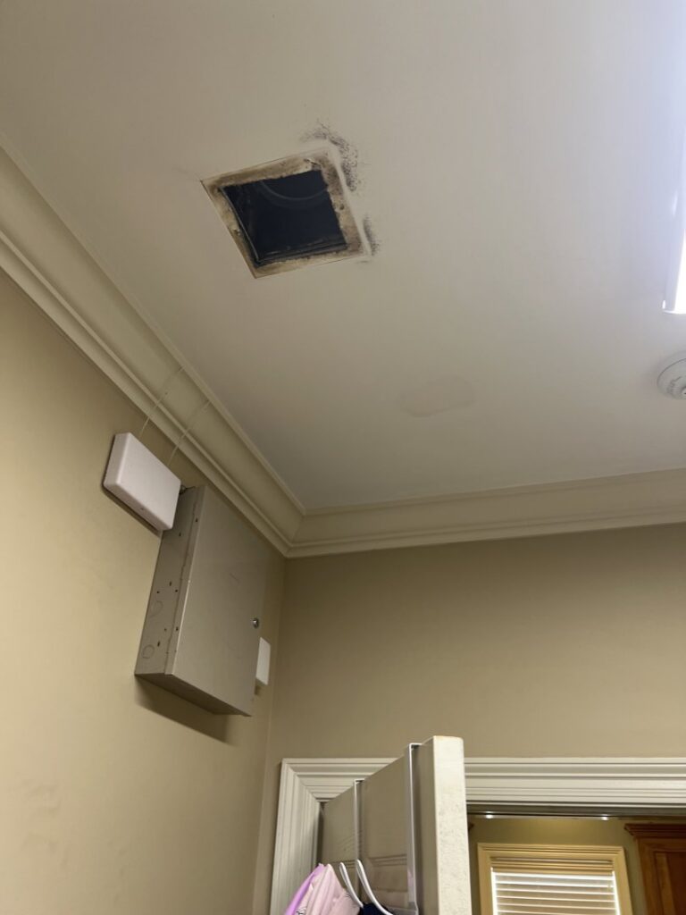 A ceiling air vent opening showing dust and potential mold, indicating a need for HVAC cleaning by AirHero.Pro in Lafayette, LA.