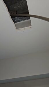 A view into a ceiling duct opening, showing ductwork during an inspection by Naranjo Heating & Cooling Specialist Inc. in Joliet, IL.