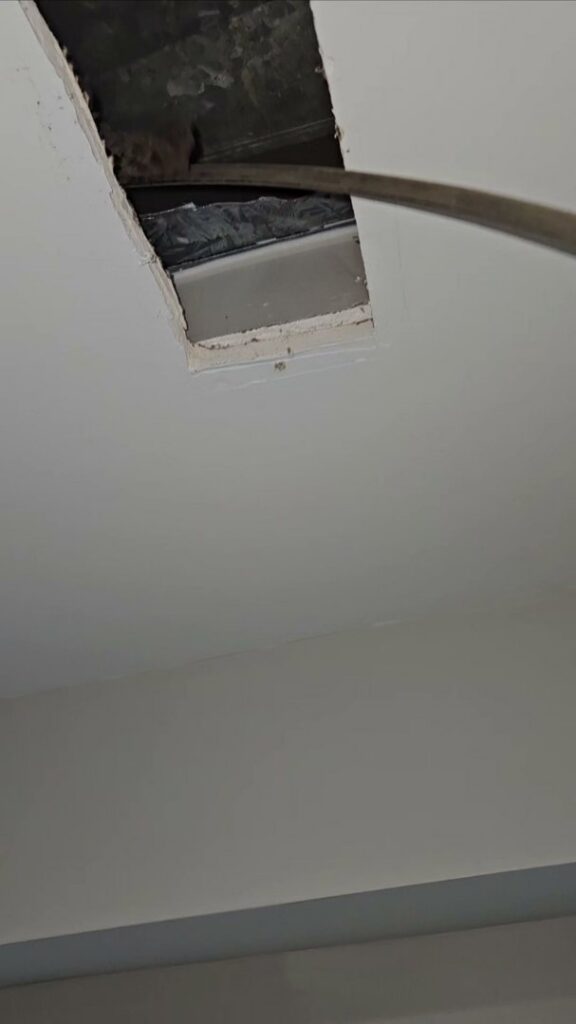 A view into a ceiling duct opening, showing ductwork during an inspection by Naranjo Heating & Cooling Specialist Inc. in Joliet, IL.