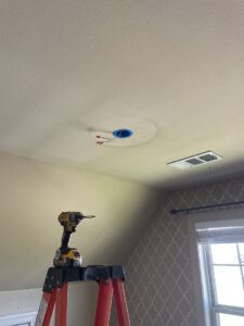 An electrician's tools set up for a ceiling electrical box installation by McCurley Electric in Little Rock, AR.