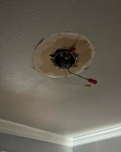 An open ceiling electrical box with wires and connectors during a repair by Prolific Resurrection LLC in New Orleans, LA.