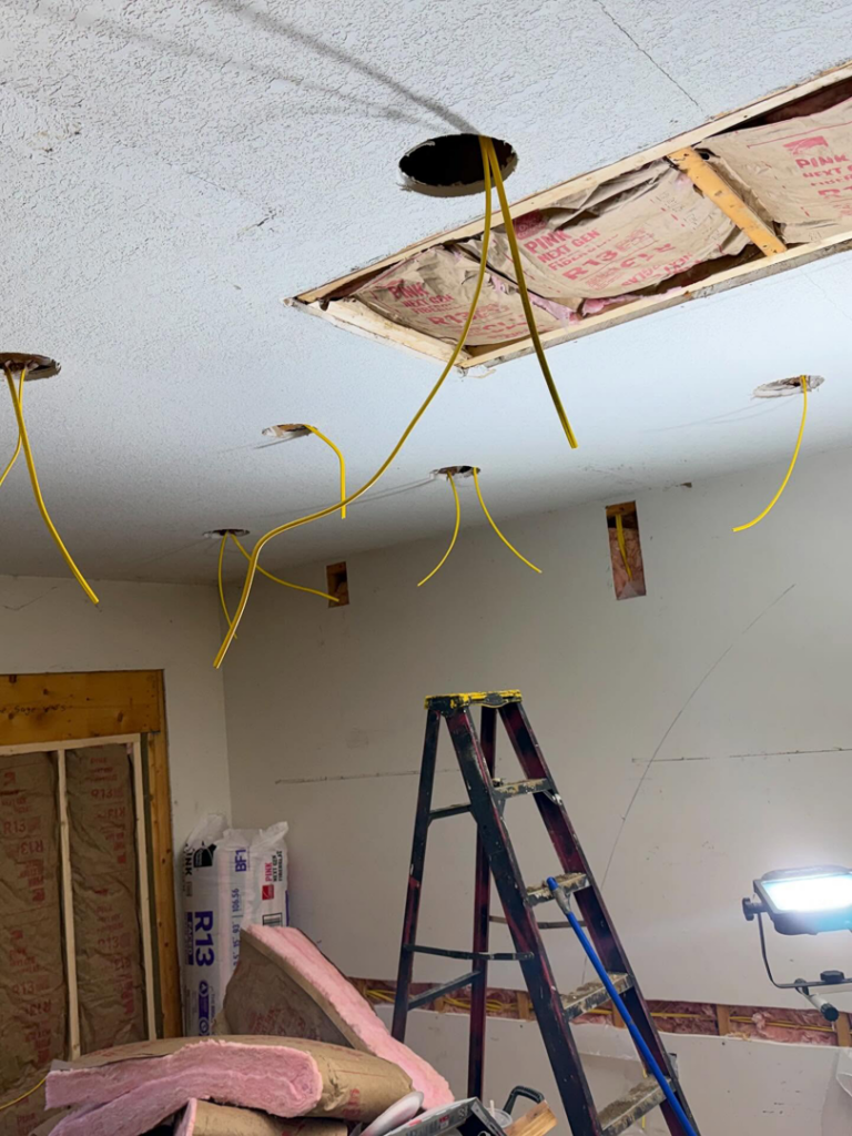 Ceiling electrical rough-in with yellow wires for lighting fixtures by J's Electrical & Maintenance Services, LLC in Columbus, OH.