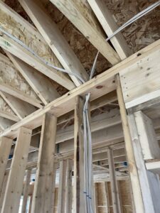 Electrical wiring running through ceiling joists during the rough-in phase by Rudis Electrical LLC in Scranton, PA.