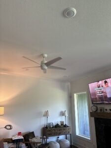 A newly installed ceiling fan and recessed lighting in a living room by 3 Phase KC in Independence, MO.
