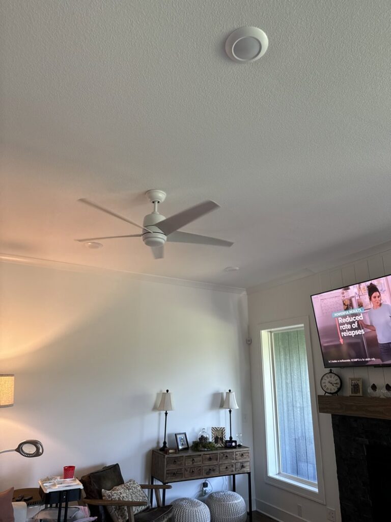 A newly installed ceiling fan and recessed lighting in a living room by 3 Phase KC in Independence, MO.