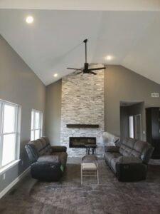 A modern ceiling fan and recessed lighting installed in a living room by Fiedler Electric in Higginsville, MO.
