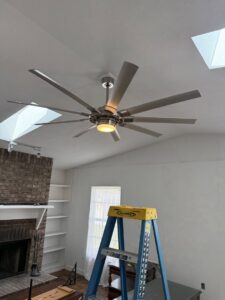 A large modern ceiling fan newly installed in a living room by A Solid Connection Electrical Services in Brandon, FL.
