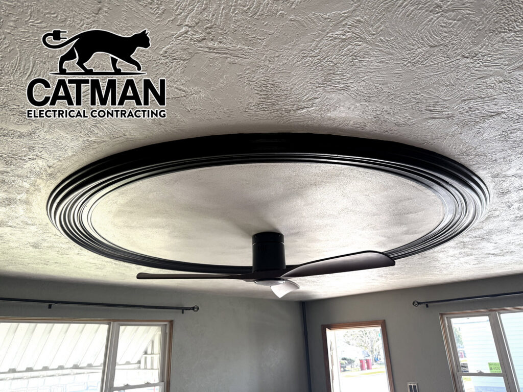A modern ceiling fan with a decorative medallion installed on a ceiling, showcasing work by Catman Electrical Contracting in Dallas, PA.