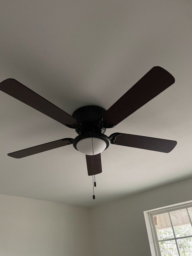 A newly installed ceiling fan with a light kit in a room by Greater Baton Rouge Electric in Baton Rouge, LA.