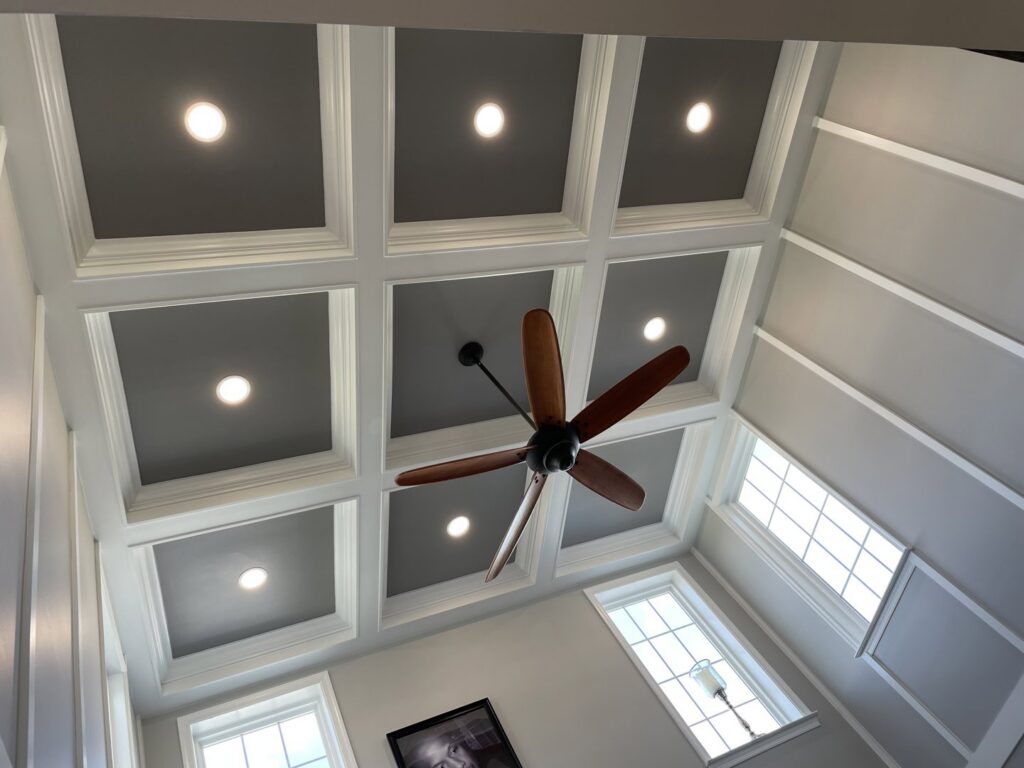 A newly installed ceiling fan in a room with a coffered ceiling, providing air circulation services by L & R Electrical and HVAC Services in San Marcos, CA.