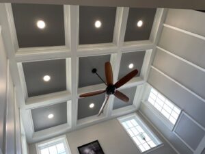 A newly installed ceiling fan in a room with a coffered ceiling, providing air circulation services by L & R Electrical and HVAC Services in San Marcos, CA.
