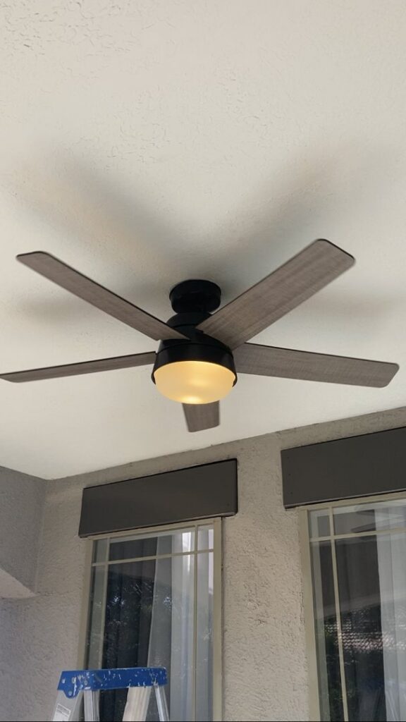 A newly installed ceiling fan with a light kit on a patio ceiling by Calhoun Electric Inc. in Rio Rancho, NM