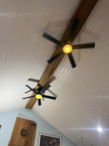 Two ceiling fans with lights installed on a wooden beam by Power House Electrical LLC in Johnson City, TN