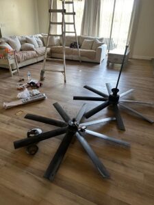 New ceiling fans on the floor ready for installation, part of an electrical project by MCM Electrical Services LLC in Phoenix, AZ
