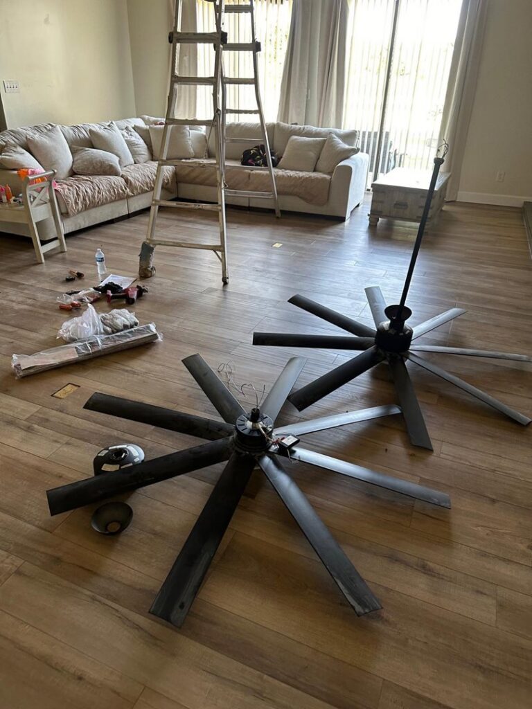 New ceiling fans on the floor ready for installation, part of an electrical project by MCM Electrical Services LLC in Phoenix, AZ