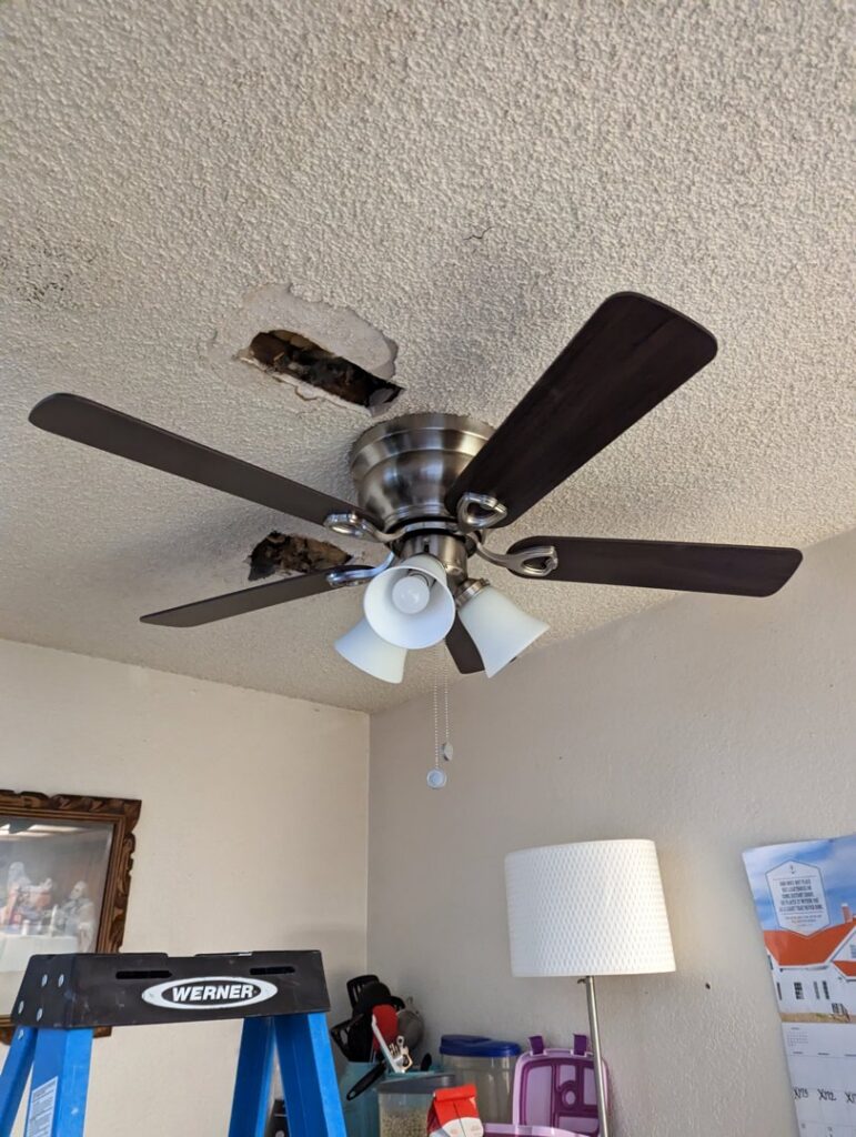 A ceiling fan with exposed wiring, indicating an ongoing installation or repair project by Primo's Electrical Services in San Diego, CA.