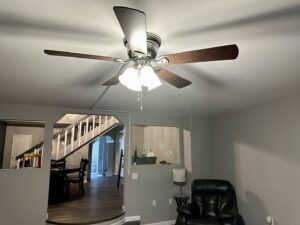 A newly installed ceiling fan with integrated lighting in a living room by Lighten Up Electric, LLC in Cranston, RI.