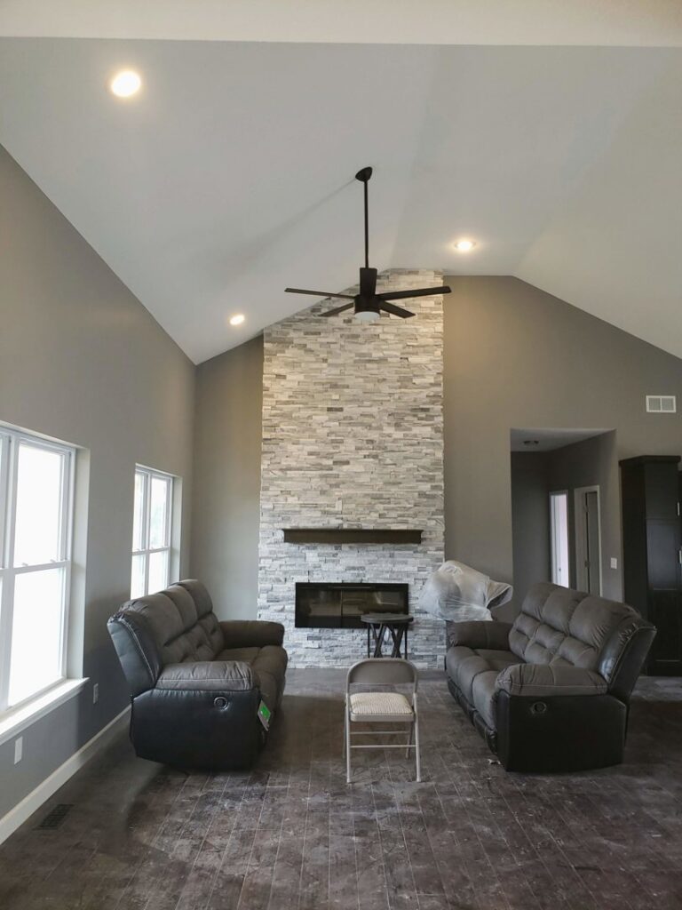 A modern living room featuring a newly installed ceiling fan and recessed lighting by Fiedler Electric in Higginsville, MO.