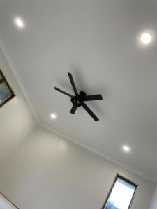 A newly installed ceiling fan and recessed lighting on a white ceiling by C&J Electric in Miles City, MT.