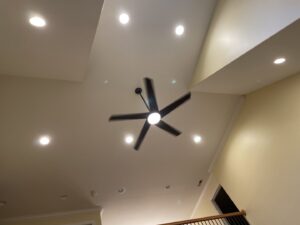 Installed ceiling fan and recessed lights in a modern ceiling by HLR Electric Company, LLC in Durham, NC.