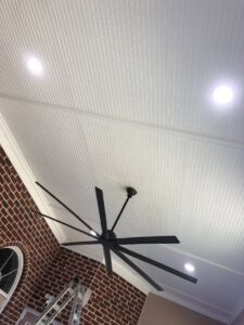 A large ceiling fan and recessed lighting fixtures installed on a white ceiling by PTech Installs in Columbus, GA.