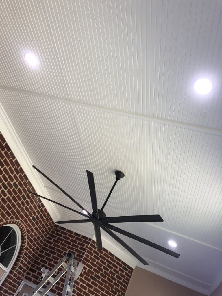 A large ceiling fan and recessed lighting fixtures installed on a white ceiling by PTech Installs in Columbus, GA.
