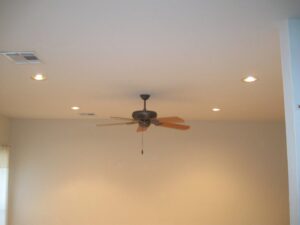A ceiling with a fan and multiple recessed lights, demonstrating electrical installation by Warner Electric Service, LLC in Broken Arrow, OK.