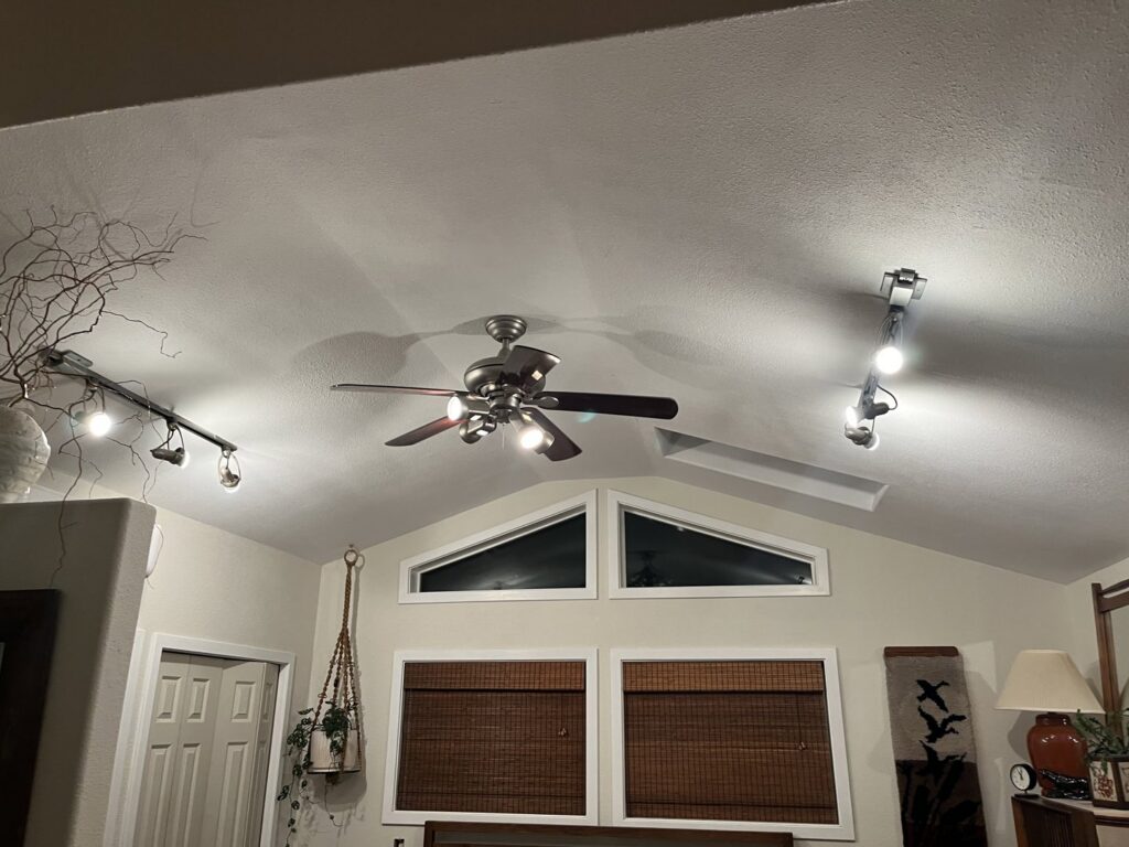 A newly installed ceiling fan and track lighting fixtures by Gold Electric INC in Bend, OR.