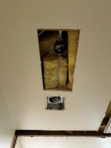 Ceiling openings showing a fan motor and a vent unit being installed by Break-N-Run Services in Henderson, NV.