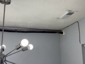 A ceiling HVAC vent and refrigerant lines installed by Inspired Heating & Cooling, Electric, Roofing, Repair LLC in Columbus, OH.