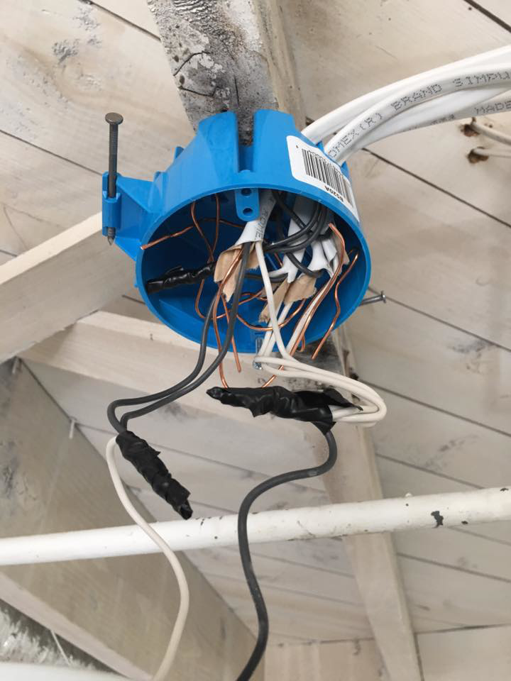 Exposed wiring in a blue electrical box for a ceiling light fixture by U-R Wired in Baltimore, MD.