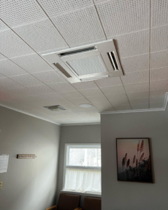 Ceiling-mounted HVAC cassette unit installed by CC Mechanical in Portland, ME.